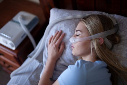 woman wearing a CPAP mask while sleeping