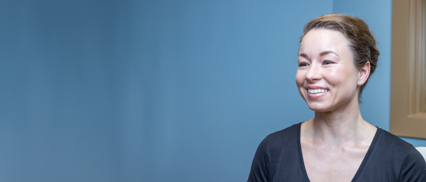Brunette woman smiling after TMJ treatment in Summerfield