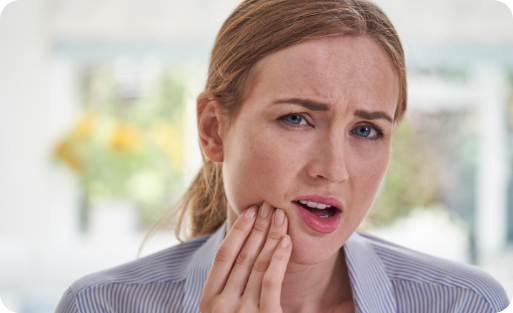 Woman holding the side of her jaw in pain