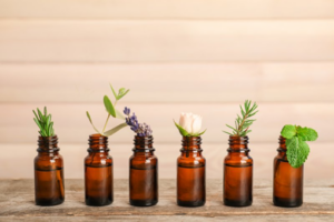 Essential oil bottles with herbs lined up in a neat row